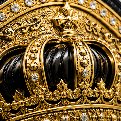 Close-up of an ornate gold and black crown with intricate designs and gemstones.