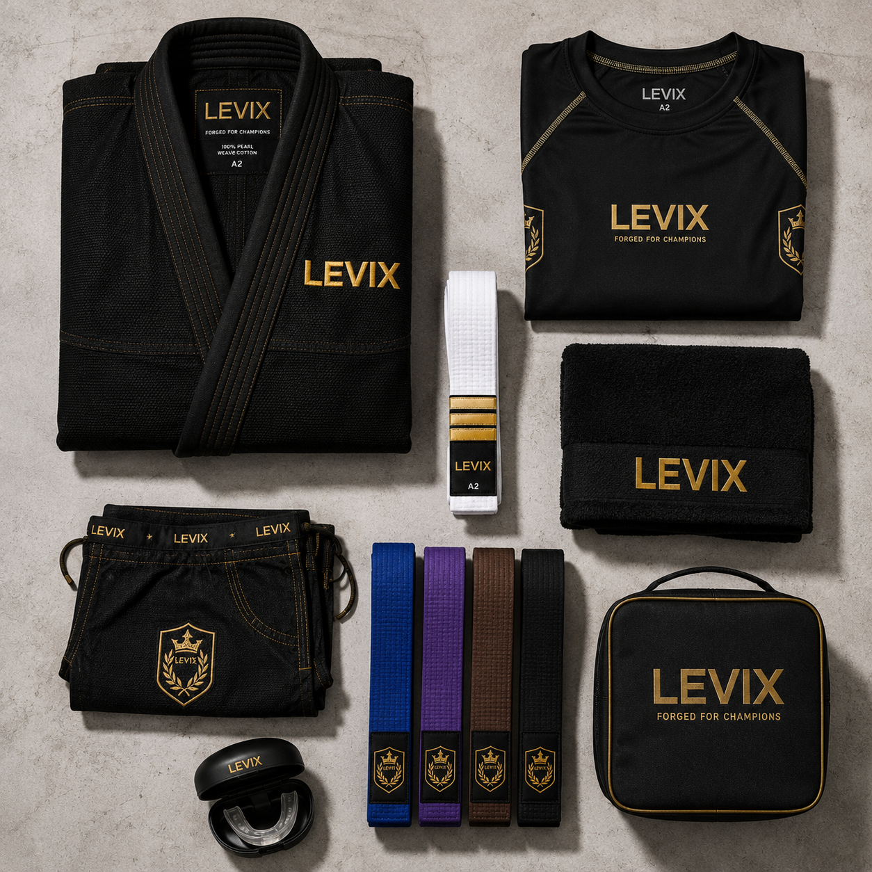 A flat lay of a black martial arts uniform set with gold and white accents from LEVIX, including a gi jacket, shorts, belt, towel, and carrying case on a light textured background.